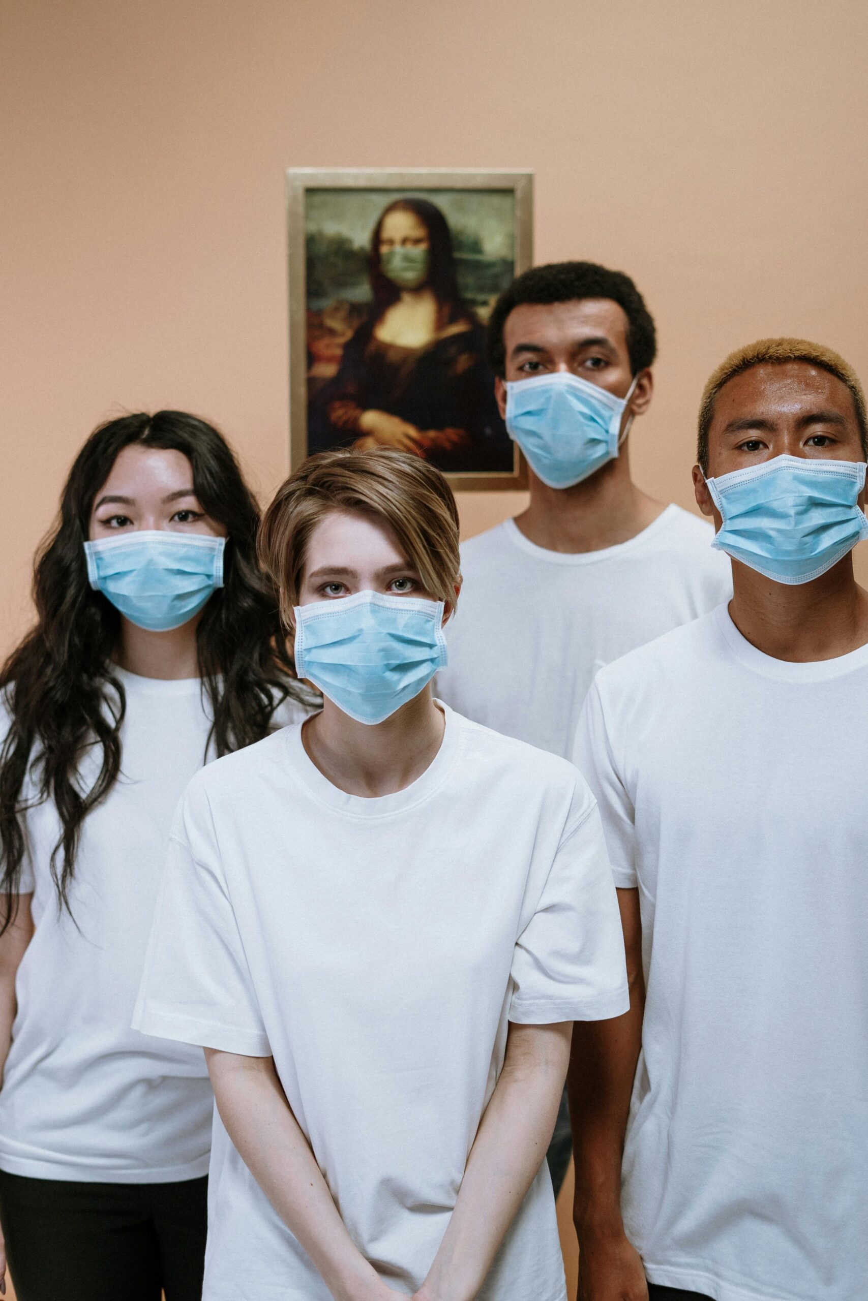 Group of healthcare professionals wearing masks in front of Mona Lisa painting for COVID-19 awareness.